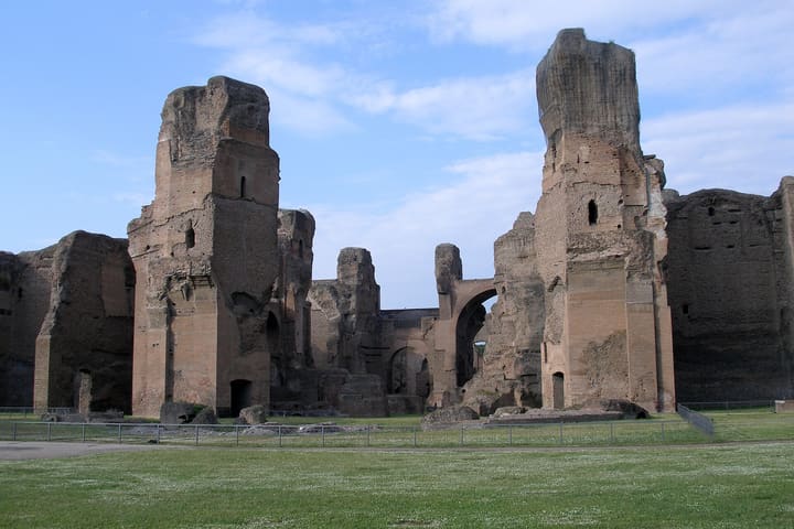 Tall brick ruins and open grounds of the Baths of Caracalla