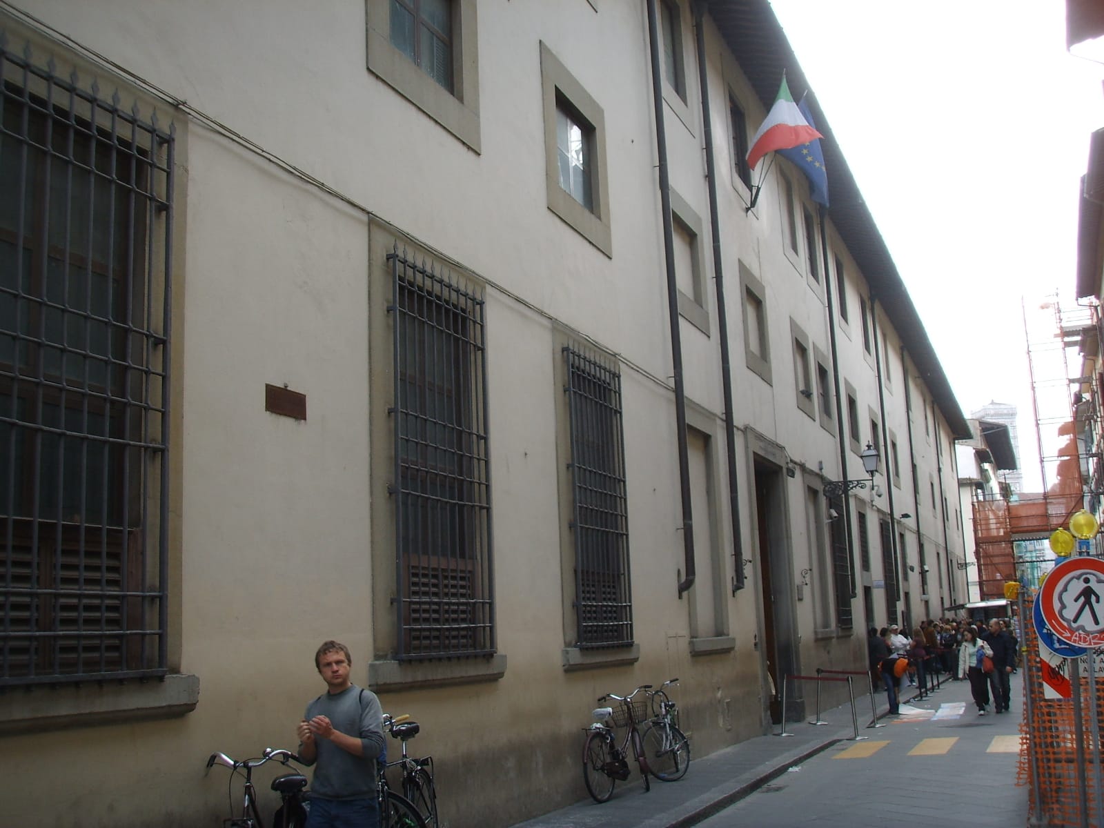 The Galleria dell'Accademia on Via Ricasoli in Florence, with visitors queueing along the street