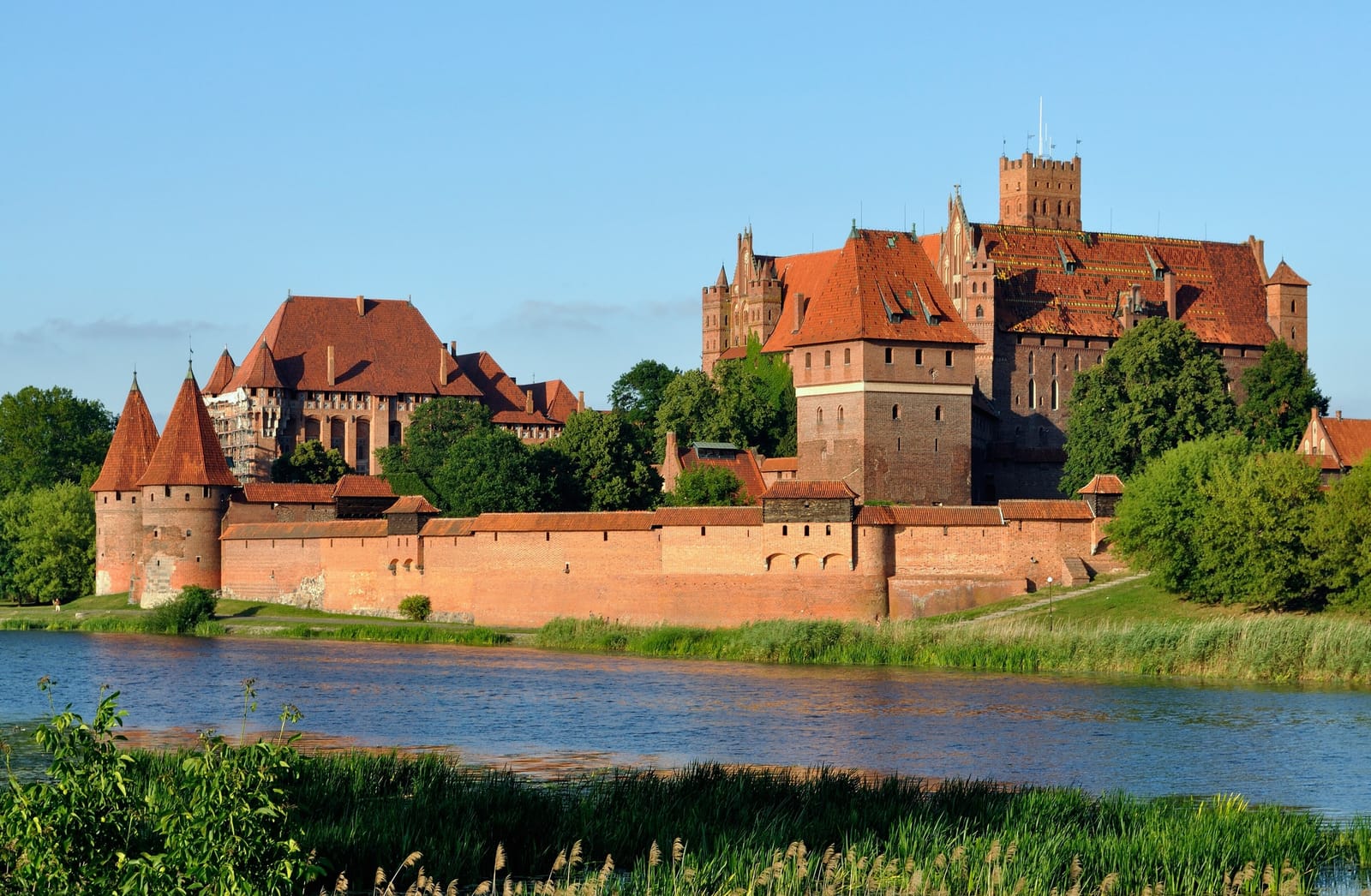 Malbork Castle's brick Gothic walls and towers above the Nogat river