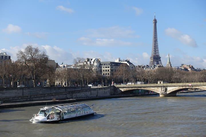 A sightseeing boat on the Seine with the Eiffel Tower in the background