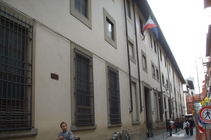The Galleria dell'Accademia on Via Ricasoli in Florence, with visitors queueing along the street