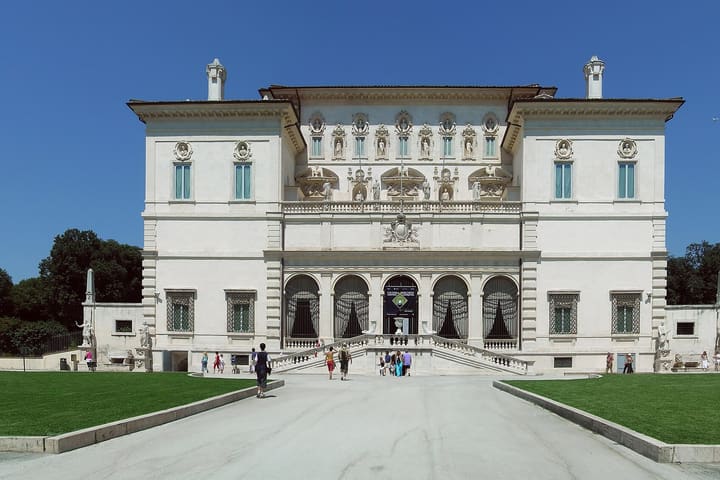 The front facade of the Borghese Gallery beneath a blue sky