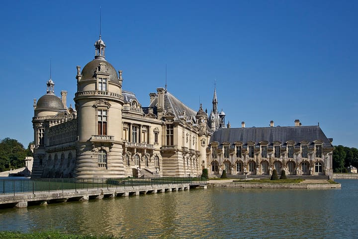 Château de Chantilly towers beside the moat